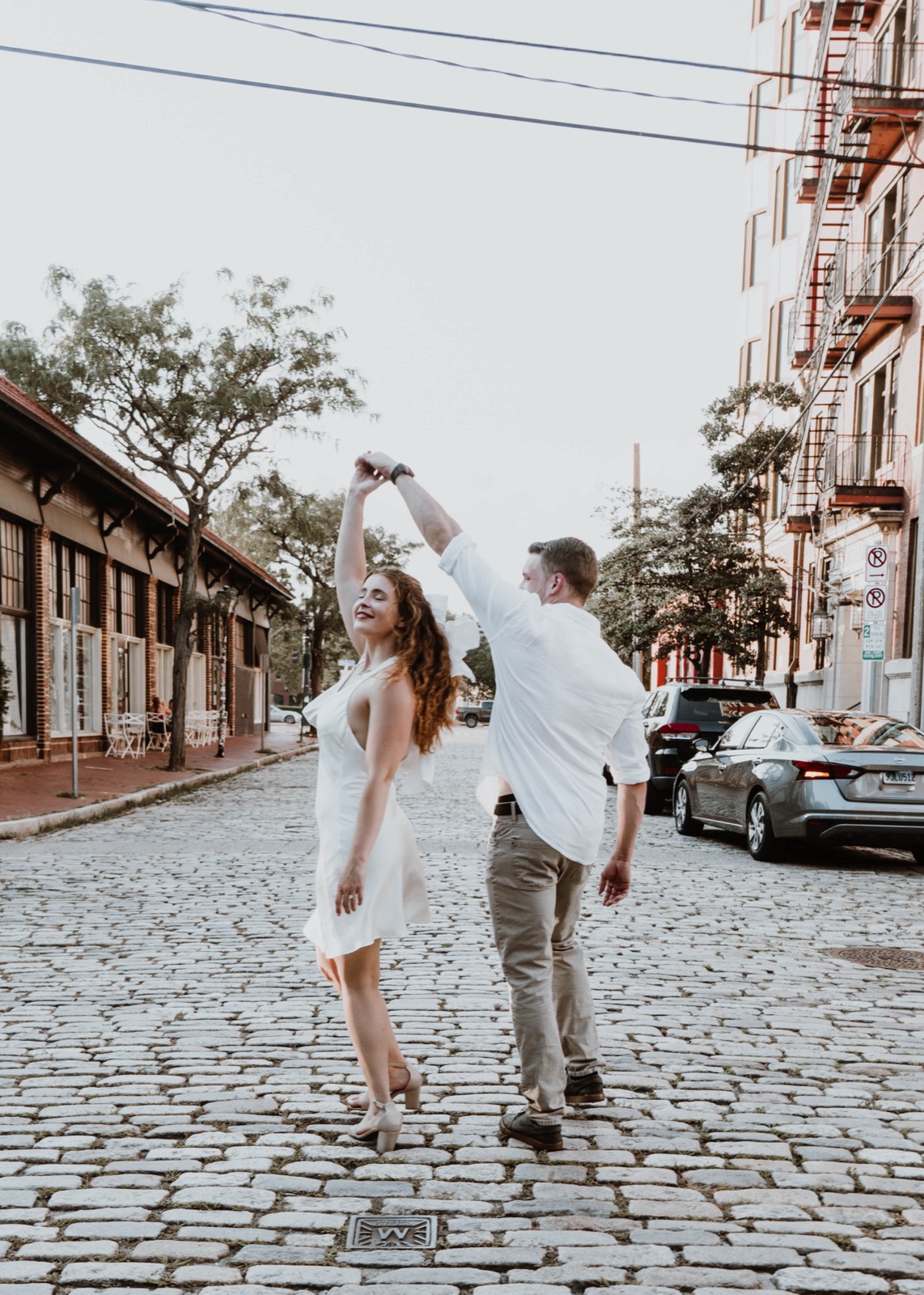 Kaylee and Tyler dancing together on a cobblestone street