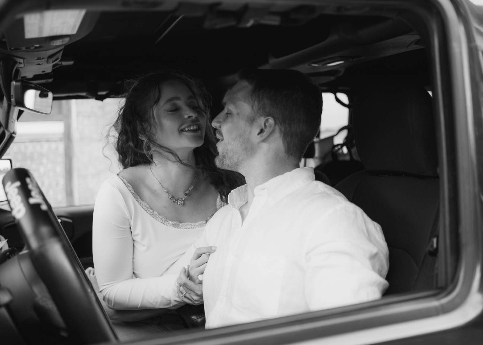 Kaylee and Tyler laughing together in their Jeep